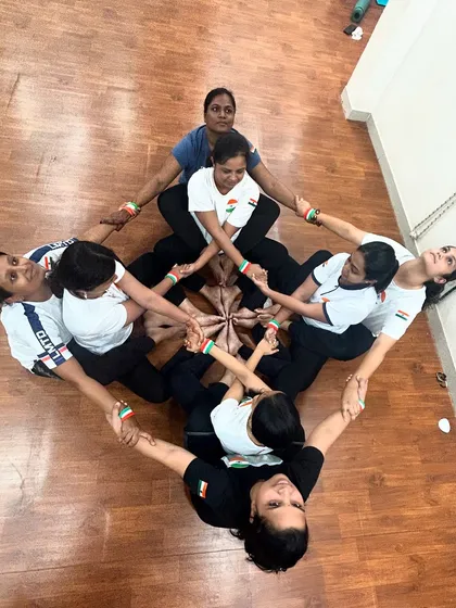An intricate group yoga pose forming a diamond shape to celebrate Independence Day. This represents the strength and unity of our nation.