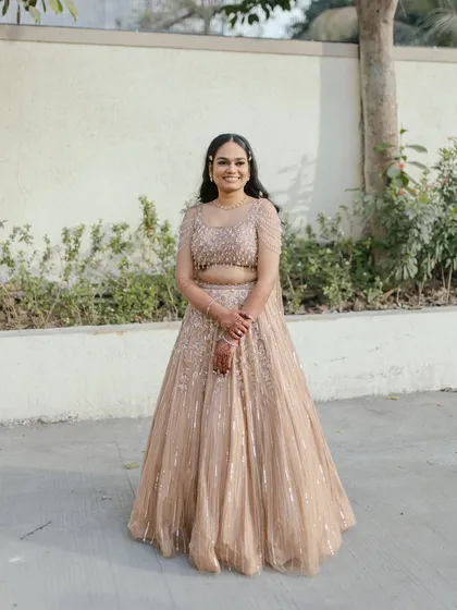 A full view of this stunning engagement look, showcasing the beautiful sequined lehenga and the soft, glowing makeup.