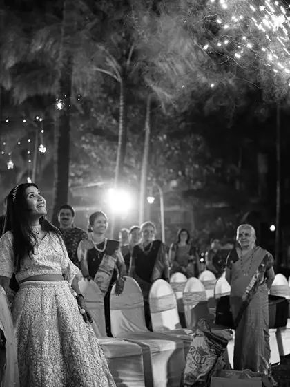 A black and white shot of the couple's grand entrance with sparklers. The monochrome effect adds a timeless, dramatic feel to the celebration.