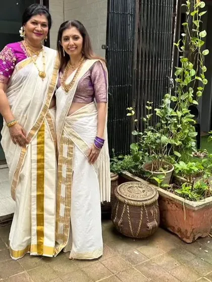 A happy Onam moment with my teacher, both of us in traditional Kerala sarees.