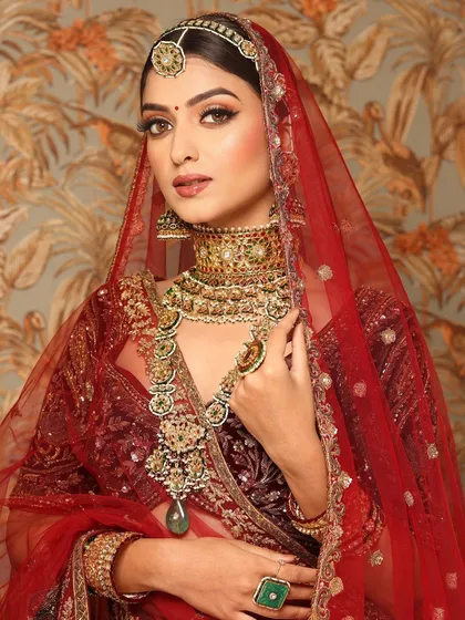 A close-up of the bride, her kohl-defined eyes and rich jewelry creating a powerful, royal statement.