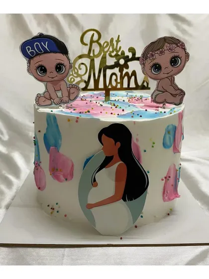 A tall baby shower cake for the "Best Mom." The design features abstract watercolor strokes in pink and blue and cute baby toppers.
