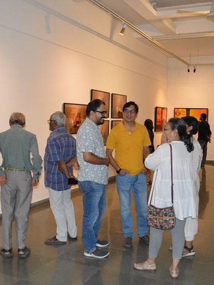 More guests mingling and discussing the art at the preview.