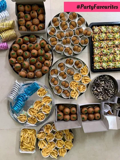 Party favorites including mini burgers, fries, cheese balls, and pizza crackers.
