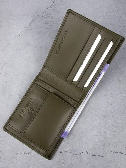An overhead shot of the open olive green wallet.