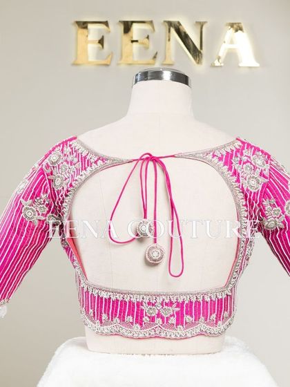 Pretty in pink, this raw silk blouse features intricate pearl and silver thread work in a striped pattern. I added floral motifs and delicate danglers on the sleeves for a touch of playful elegance.