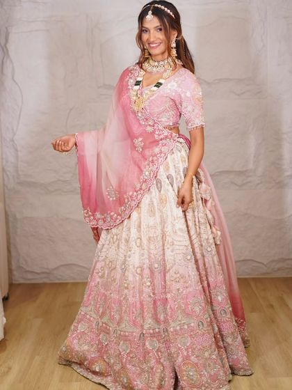 A full-length shot of our dreamy pink and white ombre lehenga. It's the perfect choice for a bride who wants to look like she stepped out of a fairytale.