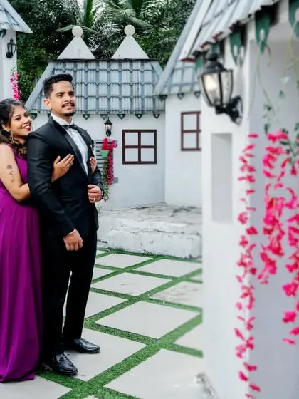 A sweet and simple portrait at a whimsical village set. The charming houses and floral decorations add a touch of fairytale romance to the scene.