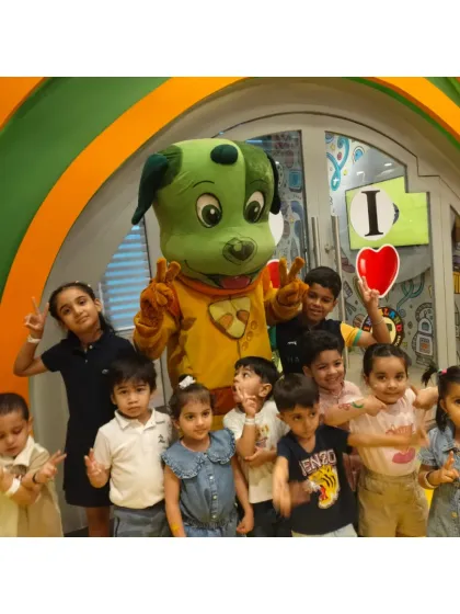 A group of friends, big and small, huddle together with Tinga Dojo for a fun and silly picture.