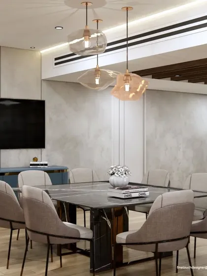 Another perspective of the dining area, showing a modern blue sideboard for storage. The combination of a neutral wall palette with pops of color and metallic accents creates a sophisticated and dynamic space.