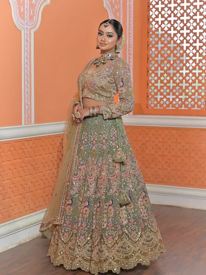 A three-quarter view that gives a great sense of the lehenga's flare and the way the jewellery adds a focal point to the overall look.