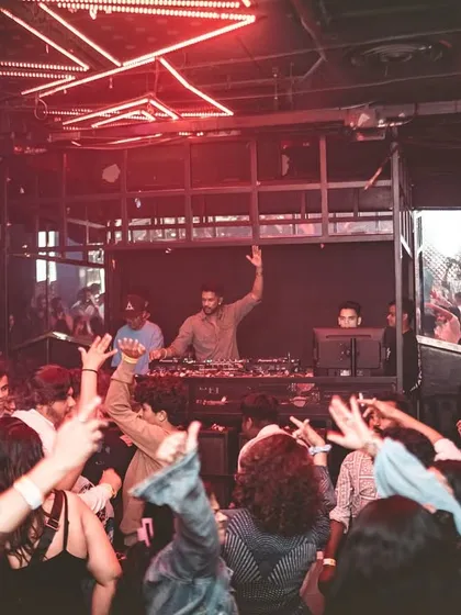 The crowd with their hands in the air at Club Illusions. My focus is always on interacting with the audience and keeping them engaged.