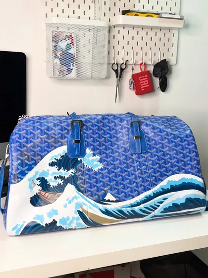 The iconic 'Great Wave' painting on a Goyard bag, seen here on my desk. A true statement piece.
