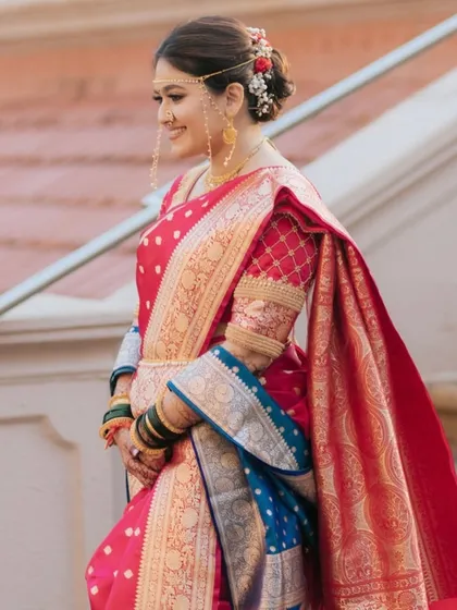 Shrawani, our beautiful Maharashtra bride, radiates elegance in this timeless traditional look, captured as she gracefully descends the stairs.