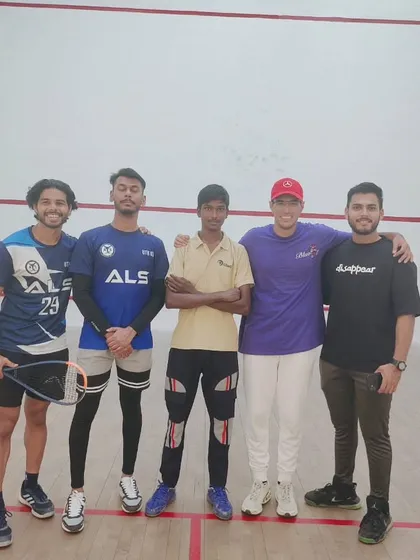 A group of smiling participants at the Amity University squash tournament. Fostering camaraderie is a key part of our events.
