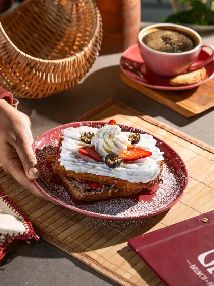 Strawberry and cream french toast. The bright red of the strawberries and the white cream create a fresh and appealing color palette.