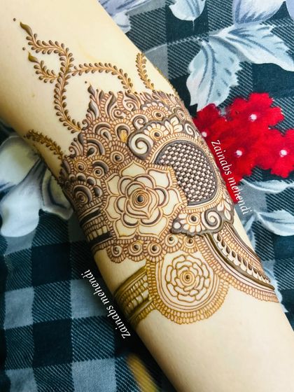 A close-up of the upper part of Leena's design, featuring a delicate rose and vine motif.