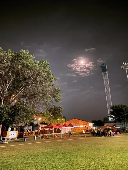 A serene night view of our expansive grounds under a full moon, showcasing the open space and ambiance perfect for evening melas and outdoor events.