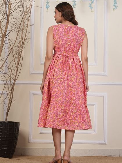 The back view of my pink floral tiered dress, showing the adjustable tie at the waist for a customized fit.
