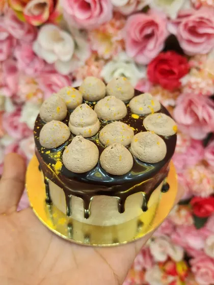 Grab one of my mini cakes for just 149 rupees. This one features a rich chocolate drip and creamy piped topping, perfect for a quick and affordable sweet fix. I always have a variety of these ready to go.
