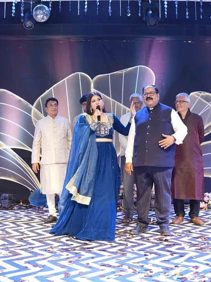 Sharing the mic with a family member, encouraging guests to participate and share their joy. This makes the event feel personal and inclusive.