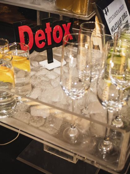 A close-up of our detox water station, featuring chilled water infused with lemon and cucumber. It's a thoughtful and healthy option for guests at any party.