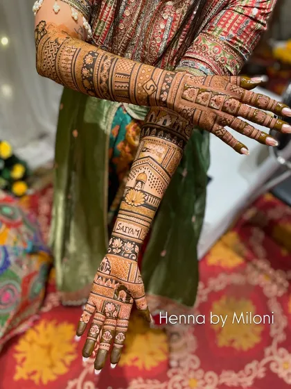A full view of the bride's stunning mehendi. The design is personalized with her name, "Satyam," and filled with traditional motifs.