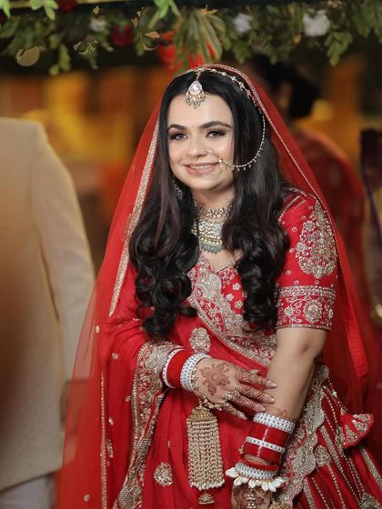 A close-up of the happy bride. Her smile says it all. We paired her red Koskii lehenga with a beautiful mint-accented necklace from Mahira Jewels for a subtle, modern contrast.