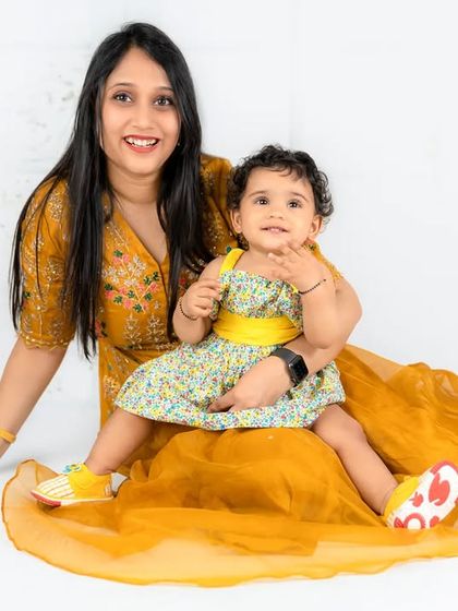 A close-up of a mother and her smiling daughter. This shot perfectly captures the joy and connection between them in a bright, happy setting.