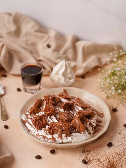 A messy, delicious dessert plate with chocolate, cream, and coffee elements. This styled shot captures the feeling of a rich, deconstructed tiramisu.