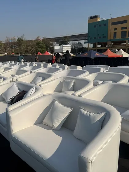 VIP seating ready for the DSP concert. We provided these comfortable white sofas to create an exclusive viewing experience, showcasing our ability to supply premium furniture for large-scale events.