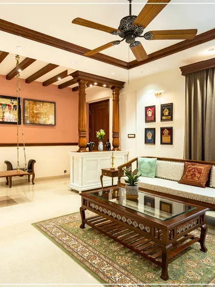 Another perspective of the Kerala-style living room, offering a complete view of the seating arrangement and traditional decor.
