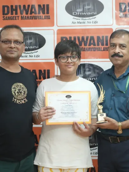 Our student with his father and one of our senior members, celebrating his achievement at the prize distribution ceremony.