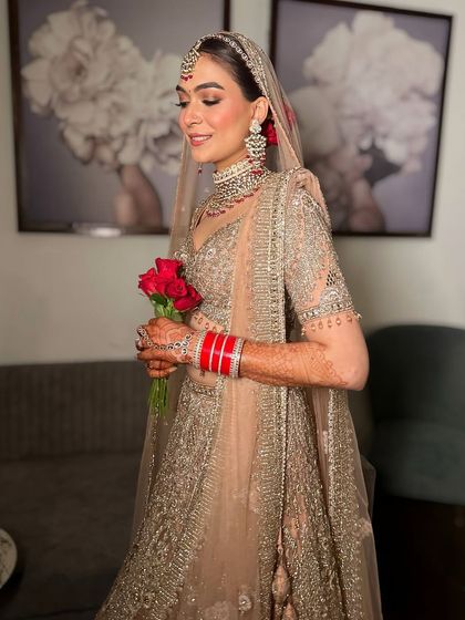 A candid, happy moment of the bride. Her makeup is designed to be flawless and radiant, ensuring she looks her best from every angle.