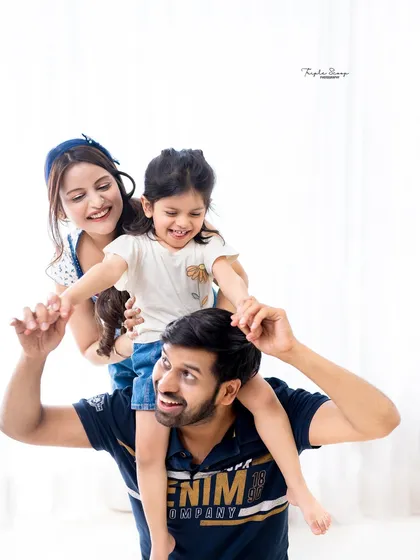 Pure family fun. A shoulder-ride for their daughter results in genuine smiles and a photo that is bursting with energy and happiness.