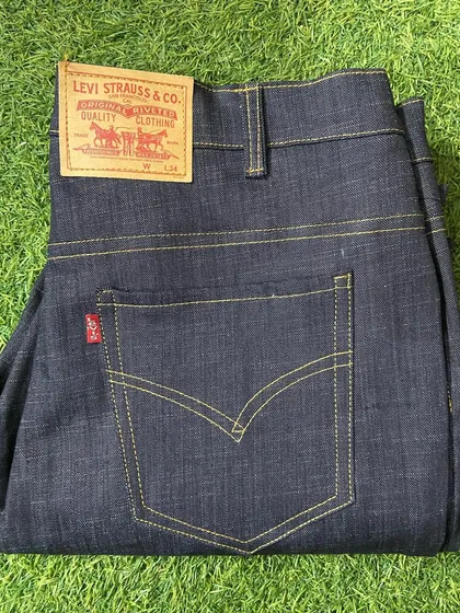 A pair of classic, dark raw denim jeans made to measure. I focus on getting the details right, from the iconic back pocket stitching to the durable construction, for a pair that lasts.