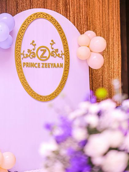 A beautifully detailed shot of the "Prince Zeeyan" royal insignia, with soft-focus flowers in the foreground. It's these small, personalized touches that make a celebration unique.
