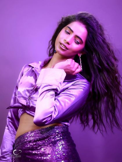 A soft and graceful pose with a downward glance. The movement in her hair adds a beautiful, dynamic element.