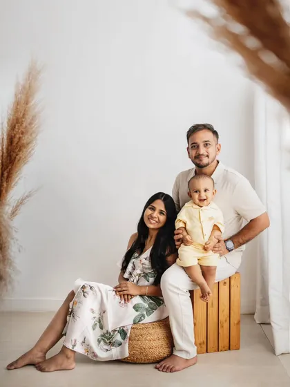 This is a beautiful family portrait from a first birthday session. I used my studio's boho props, like pampas grass and a wooden stool, to create a warm and stylish setting.