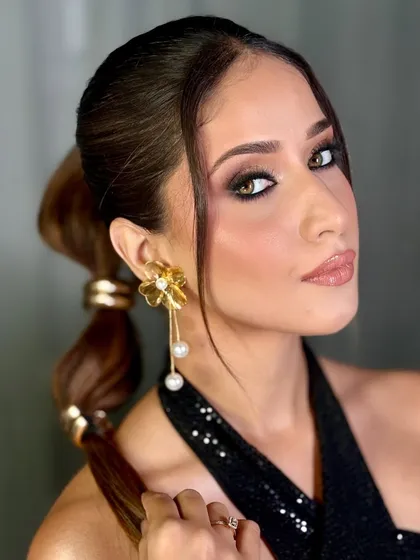 A close-up of a glamorous look perfect for a cocktail party or reception. The focus here is on a sharp, blended smokey eye and luminous skin that looks stunning in photos.