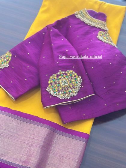 A purple blouse with large, statement kundan and stone work motifs.