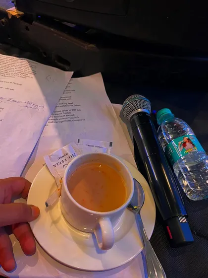 The essentials for any show: my script, my mics, a water bottle, and a hot cup of chai.