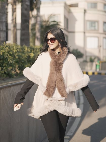Walking in the winter sun with my fur cape. It's perfect for a day of shopping or a brunch date.