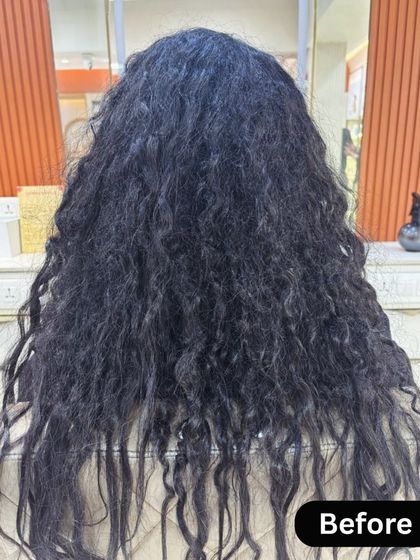 A dramatic "before" picture showing very curly and frizzy hair prior to a Nanoplastia treatment.