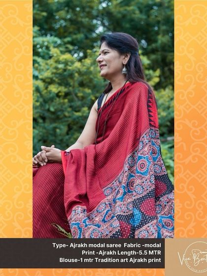 A smiling customer looking lovely in our red Ajrakh modal saree. The intricate patterns and comfortable modal fabric make it a joy to wear.