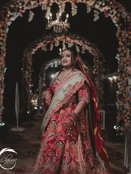 The entrance tunnel provides a perfect frame for capturing the bride in all her glory. The soft lighting and floral arches create a romantic and flattering portrait setting.