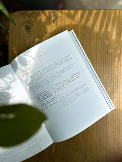 Sunlight falling on a book about mindful drinking. We believe in offering choices that support an intentional lifestyle.