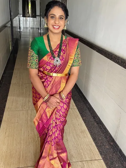 A happy client ready for her event. This is the complete look, from the perfectly draped South Indian silk saree and traditional jewelry to the fresh, glowing makeup and classic braided hairstyle.
