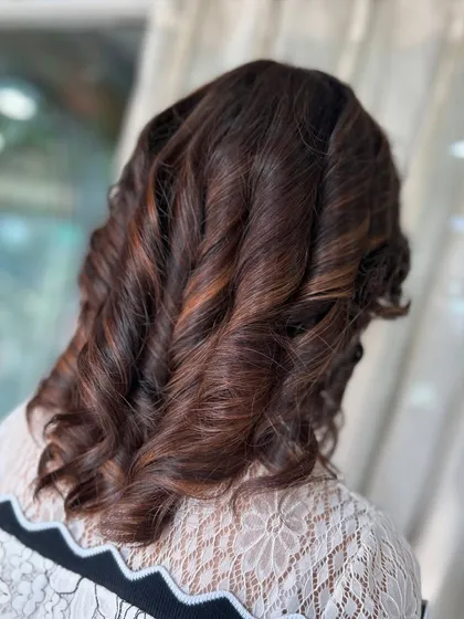 Another angle of these beautiful curls. The styling is designed to hold its shape while still having soft movement and bounce.