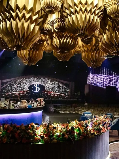 A custom-designed origami ceiling installation served as a dramatic focal point above the bar. This, combined with a massive LED backdrop, created a modern and artistic nightclub vibe for this Sangeet.
